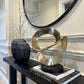 Ribbon Knot Sculpture on Black Wooden Base